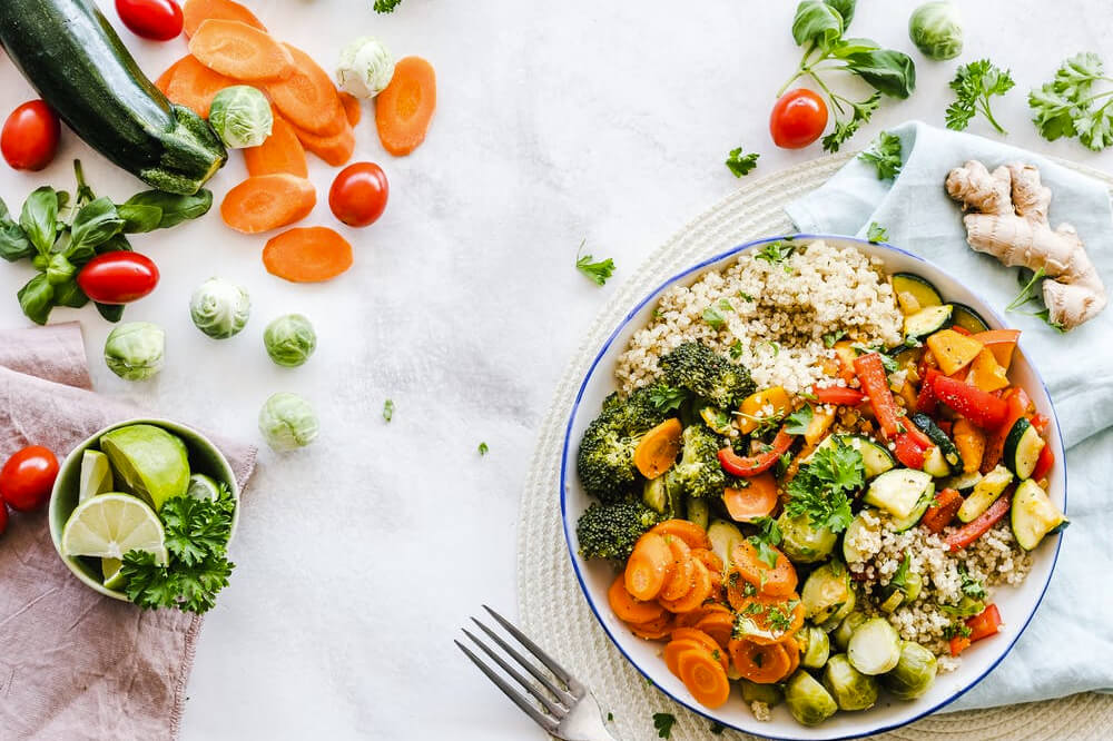  fresh and colorful bowl of salad featuring a variety of vegetables on a rustic wooden table