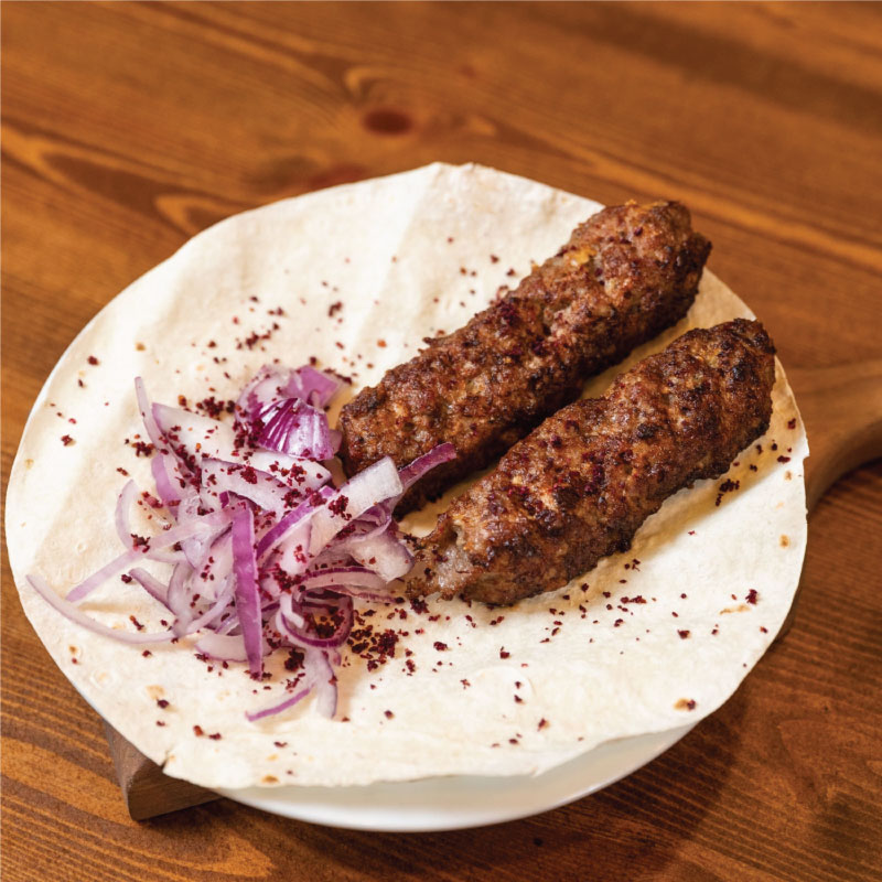 Lyulya kebab with onions and bread.